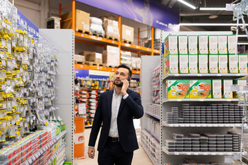 businessman in a business suit at a hardware store with a grocery basket