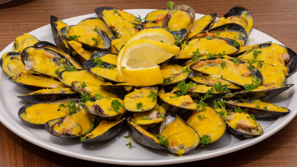 Mussels in saffron sauce served with lemon