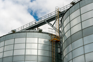 A large modern plant for the storage and processing of grain crops. view of the granary on a sunny day against the blue sky. End of harvest season.