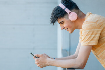 young man with mobile phone and headphones isolated