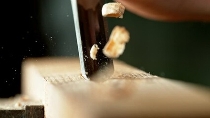 Super slow motion of detail of carving wood with a chisel. Low depth of focus, super macro shot. Filmed on high speed cinema camera, 1000 fps.