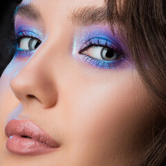 Gorgeous brunette with bright shining makeup, blue eye shadow, close-up face, blue eyes. Bright makeup - 514529925