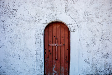 Wooden door of a hermitage in the town 