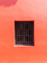 One window on a red wall.