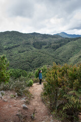 Fototapeta na wymiar Young woman walking on Bogota mountain path 