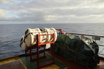 life rafts stowed on the cradles of a ship