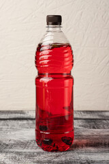 Lemonade, homemade lemonade in a bottle, on a white wooden background