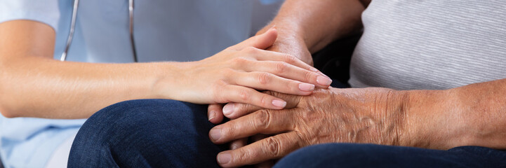 Fototapeta premium Senior Man Sitting On Wheelchair With Female Nurse