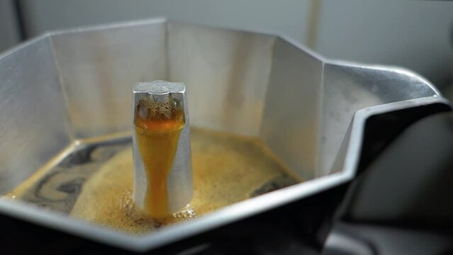 Making Coffee Moka. Detail of coffee being brewed in an Italian Moka. Espresso coffee preparation using Italian Moka coffee maker