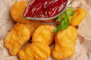Fish and chips. Crispy breaded chicken fillet, strips. Chicken nuggets with sauce. Fast food, takeaway food.