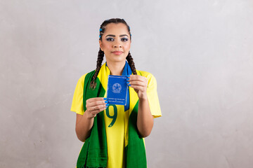 afro woman in brazil clothes holding brazilian work card