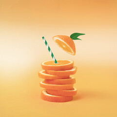 Summer composition with fresh stacked orange slices and straw on vibrant orange background. Creative healthy diet concept. Organic tropical fruit juice.