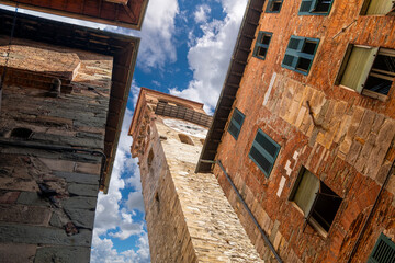 The Torre delle Ore clock tower seen from the street below in the medieval walled town of Lucca...