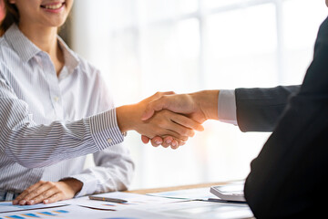 Young businesspeople shaking hands in the office, Finishing successful meetings, a handshake of business people deal business, Teamwork
