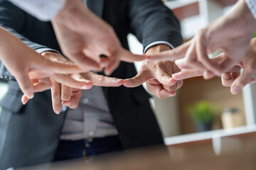 Businessman or partner in Asia team Businessman bumping his fingers into a star After completing the agreement in the office collaborative work of colleagues team work concept
