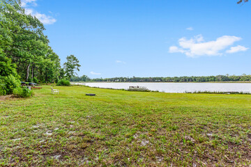 Grassy area overlooking a nice lake with a boat on the edge