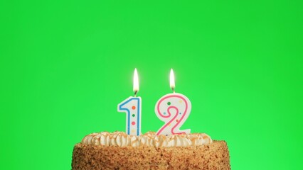 Cake with lighted candle number 12. Green screen background. Isolated.
