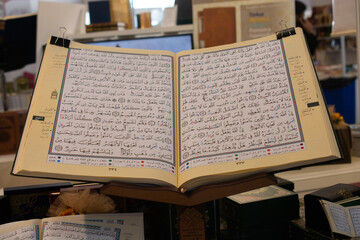 Fototapeta premium Quran wide open in wooden placemat.