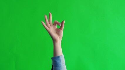 Hand shows gesture fingers okay, ok, all right. Green screen