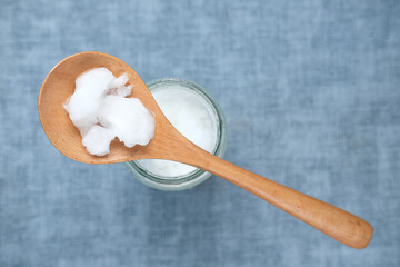 spoon with cold coconut oil on table 