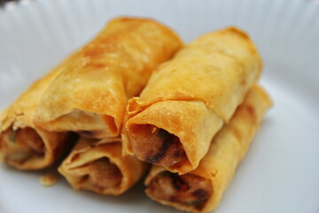 Fried spring rolls placed in a white plate, fried spring rolls are a popular Asian dish.