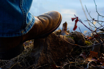 cowboy boot on rock overlooking the water, 
