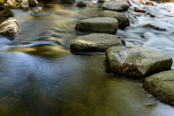 Fototapeta na wymiar close up of slow flowing water over the rocks