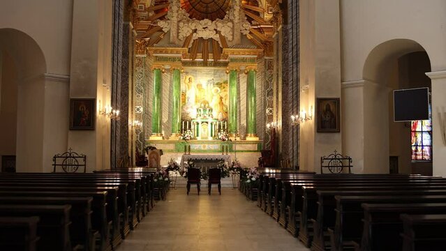 large catholic church with benches and an altar