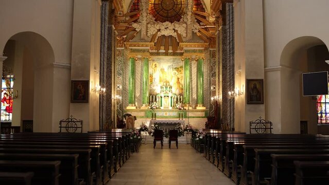 large catholic church with benches and an altar