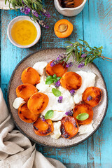 Grilled apricots with buratta cheese , granola and honey. Summer breakfast