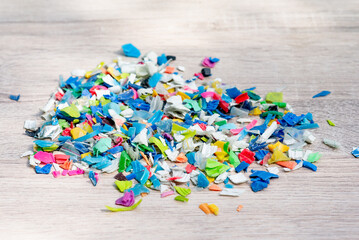 A Pile of PET bottle flakes, Plastic bottle crushed, Small pieces of cut colorful plastic bottles...