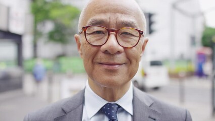 Portrait of senior professional Asian male looking to camera with a gentle smile - Powered by Adobe