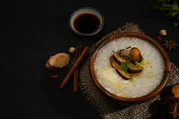 Rice porridge, rice gruel or congee with shiitake mushroom, boiled egg ,sliced ginger and slice...