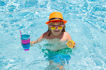 Fototapeta na wymiar Kid boy playing in swimming pool. Summer vacation concept. Summer kids portrait in sea water on beach.