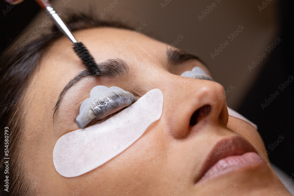 Wall mural closeup of a woman's face during an eyelash and eyebrow treatment