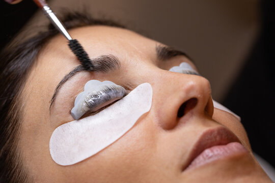 Closeup of a woman's face during an eyelash and eyebrow treatment