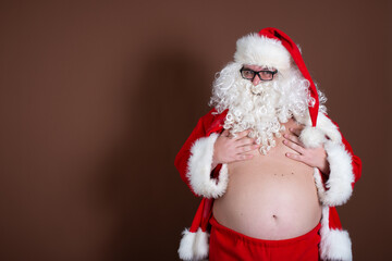 Funny fat man dressed as Santa Claus. Fitness and healthy lifestyle.