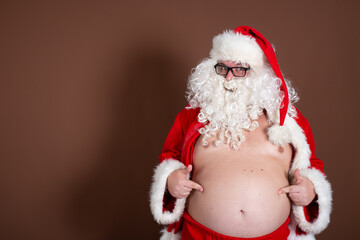 Funny fat man dressed as Santa Claus. Fitness and healthy lifestyle.
