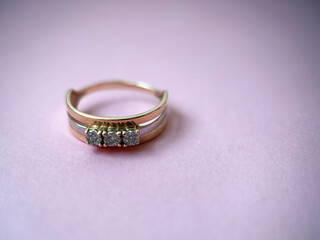 Gold diamond ring on pink isolated background. Red Gold Ring