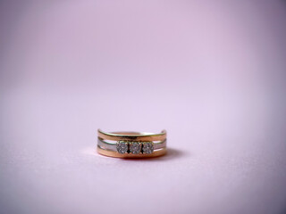 Gold diamond ring on pink isolated background. Red Gold Ring