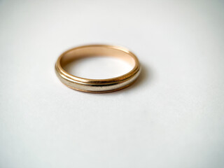 Gold wedding ring on a white isolated background. Red and white gold ring