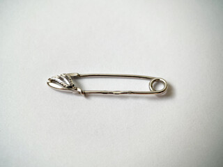 Silver pin brooch close-up on white isolated background