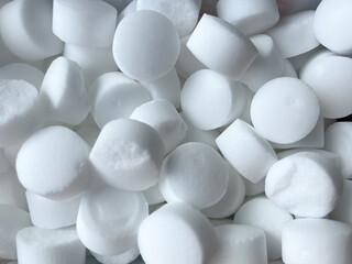 Background of tableted salt for softening water close-up
