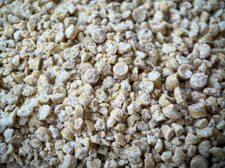 Background of corn filler for a cat's toilet. Corn filler granules close-up
