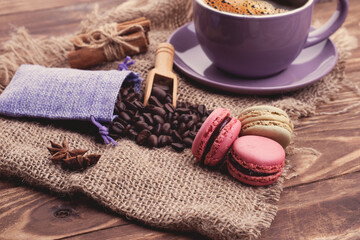 Obraz na płótnie Canvas cup of coffee, beans, cinnamon, macaroons and anise on the wooden background Coffee is the good idea