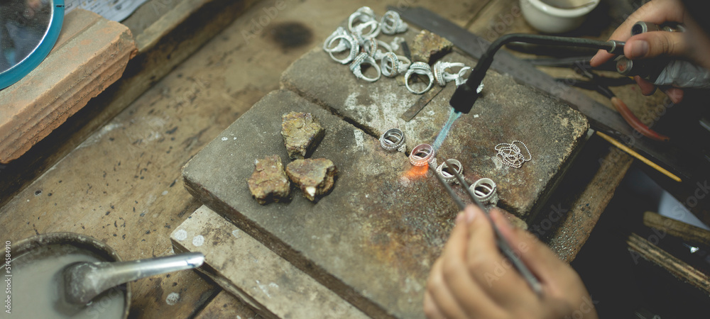 Wall mural Jeweler at work in jewelry. Desktop for craft jewelry making with professional tools. Close up view of tools. Silver jewelry. Unique local artwork in Nan Province northern thailand