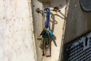 An iron padlock hangs on a closed gate