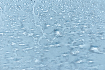 Water drops condensate on white background texture on transparent glass. backdrop glass covered with abstract drops of water.blurred image.