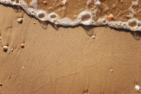 top view image of sea waves and beach sand