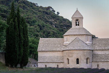 Abbey of Senanque and blooming rows of lavender flowers at sunrise. Gordes, Luberon, Vaucluse, Provence, France, Europe.